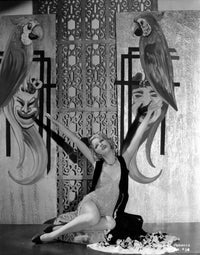 Portrait photo print of a woman on the floor with a parrot.