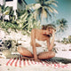 Grace Kelly sitting criss-cross on a striped towel photo print