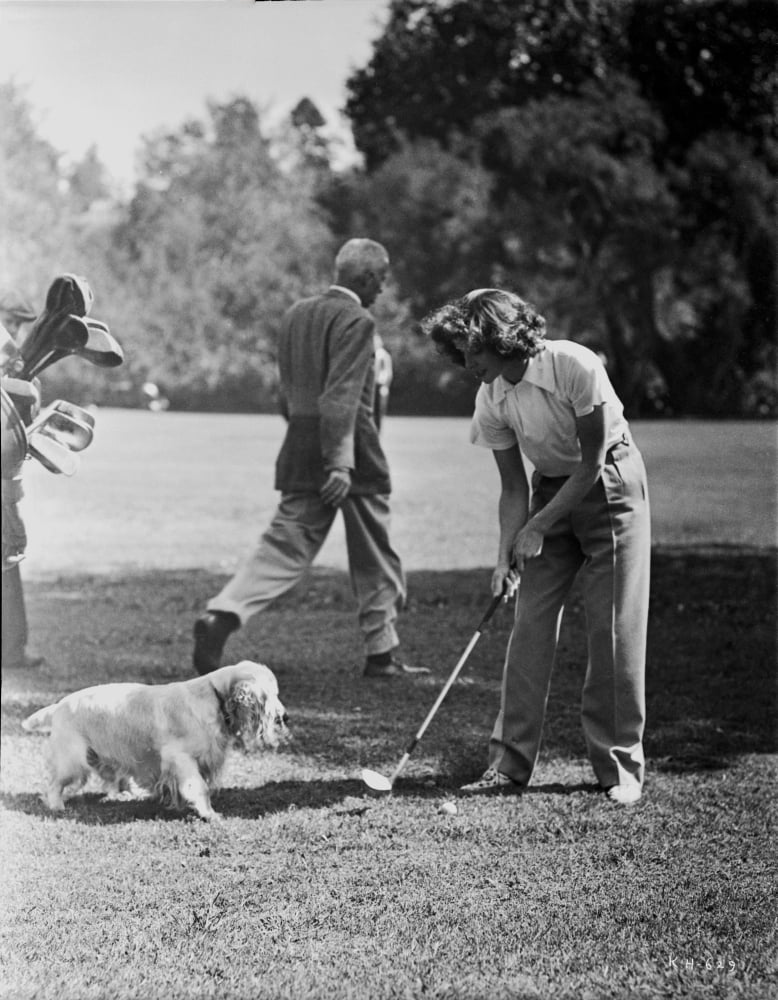Katharine Hepburn playing golf with her dog photo print.