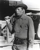Film still photo print featuring Robert Mitchum as sheriff.