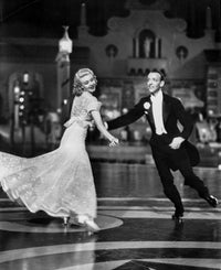 Fred Astaire and Ginger Rogers dancing photo print showcasing their smiles and elegance.