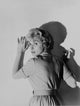Black and White Portrait of a Woman Leaning on Wall Photo Print