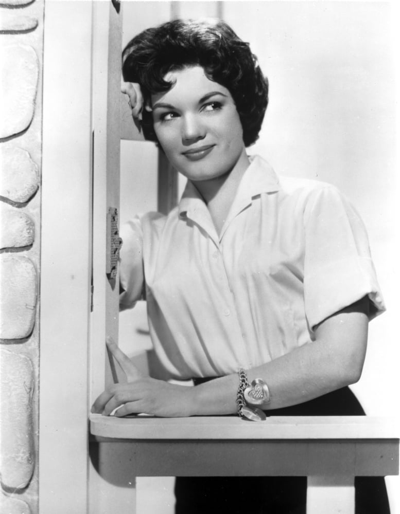 Connie Francis leaning on wall in white dress photo print
