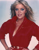Lydia Cornell posed in a red dress with a smile photo print