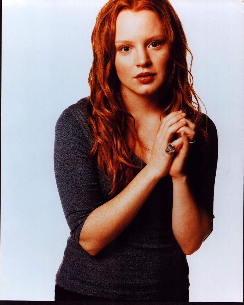 Lauren Ambrose photo print with hands up in gray top.