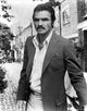 Burt Reynolds photo print in suit outdoors, available in multiple sizes.