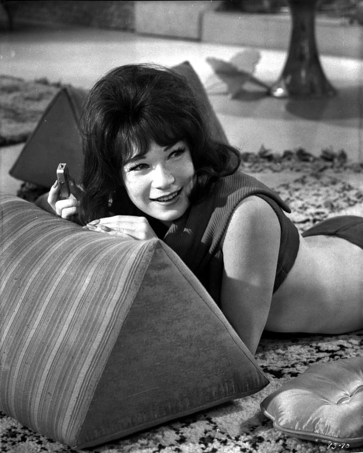 Classic photo print of Shirley MacLaine lying down, showcasing timeless Hollywood elegance.