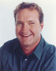Randy Quaid smiling in a blue polo shirt portrait photo print