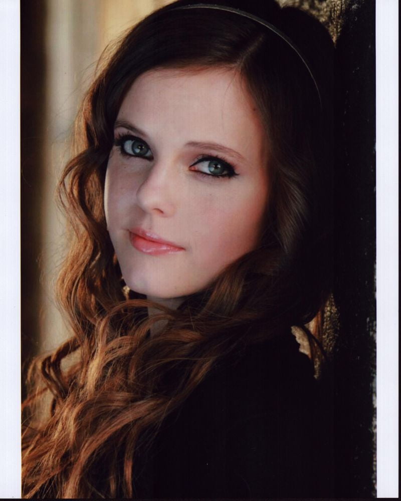 Tiffany Alvord headshot leaning on wall photo print