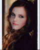 Tiffany Alvord headshot leaning on wall photo print