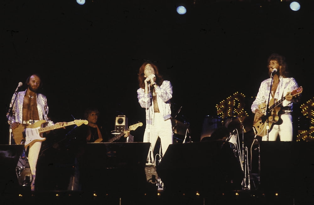 The Bee Gees live performance photo print capturing the band's iconic stage presence.