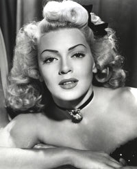 Close-up portrait of Lana Turner with ribbon and amulet necklace, vintage photo print.