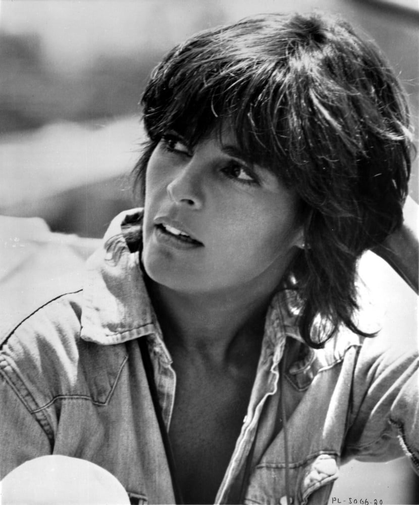 Ali MacGraw looking away wearing a denim jacket photo print.