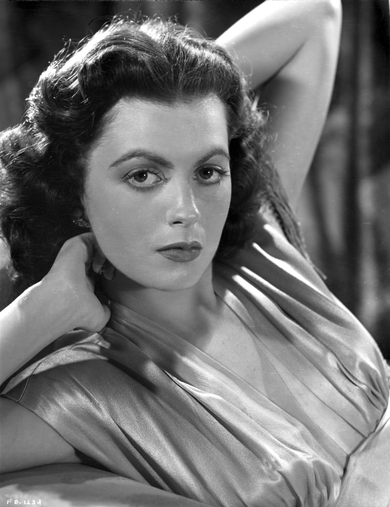 Faith Domergue photo print with hands behind head, classic Hollywood style.