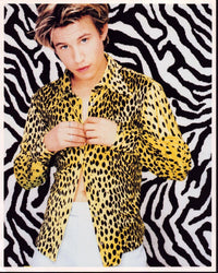 Jonathan Taylor Thomas photo print in cheetah shirt against zebra wall.