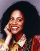 Kim Coles photo print leaning chin on hand gray background