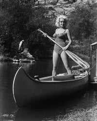 Mamie Van Doren standing in canoe photo print, available in various sizes.