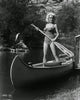 Mamie Van Doren standing in canoe photo print, available in various sizes.