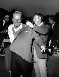 Jack Nicklaus helping Arnold Palmer put on a jacket photo print.