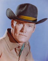Close-up portrait photo print of Chuck Connors in brown polo and hat.