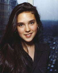 Close-up portrait photo print of Jennifer Connelly in a black coat and brown suit dress with hoop earrings.