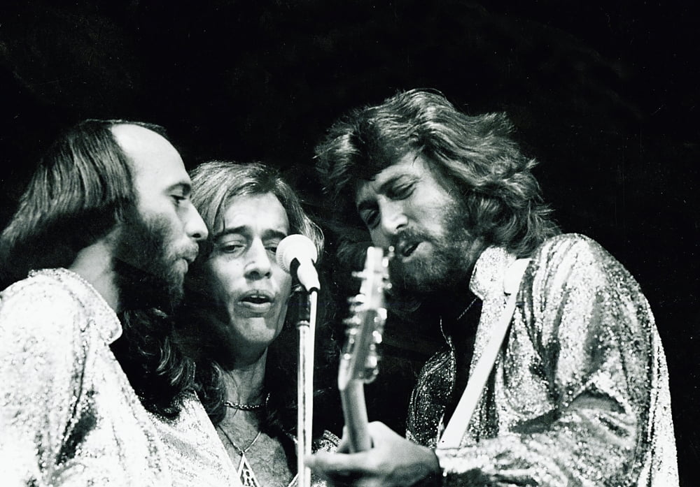 The Bee Gees live performance photo print showcasing their iconic stage presence.