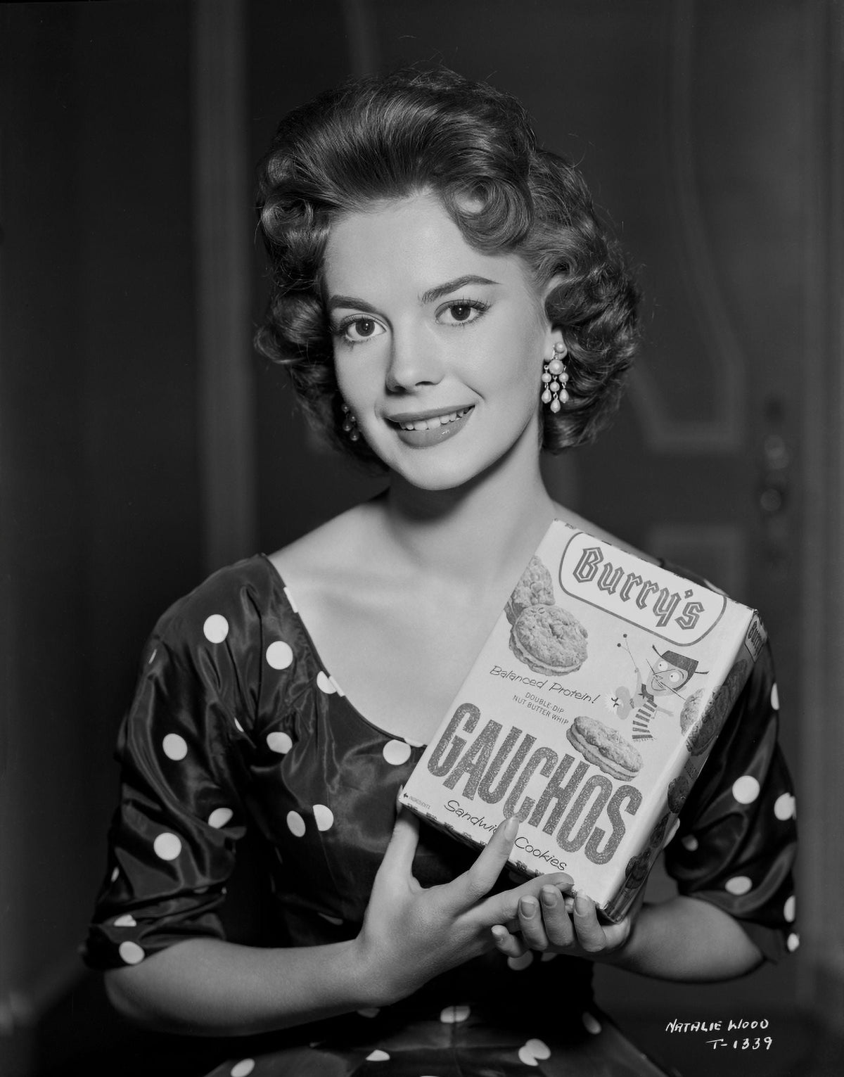 Natalie Wood photo print holding a box of cookies, vintage Hollywood charm.