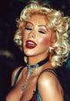 Christina Aguilera winking in a red and blue outfit with a black diamond choker photo print