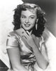 Paulette Goddard smiling in a silk blouse portrait photo print
