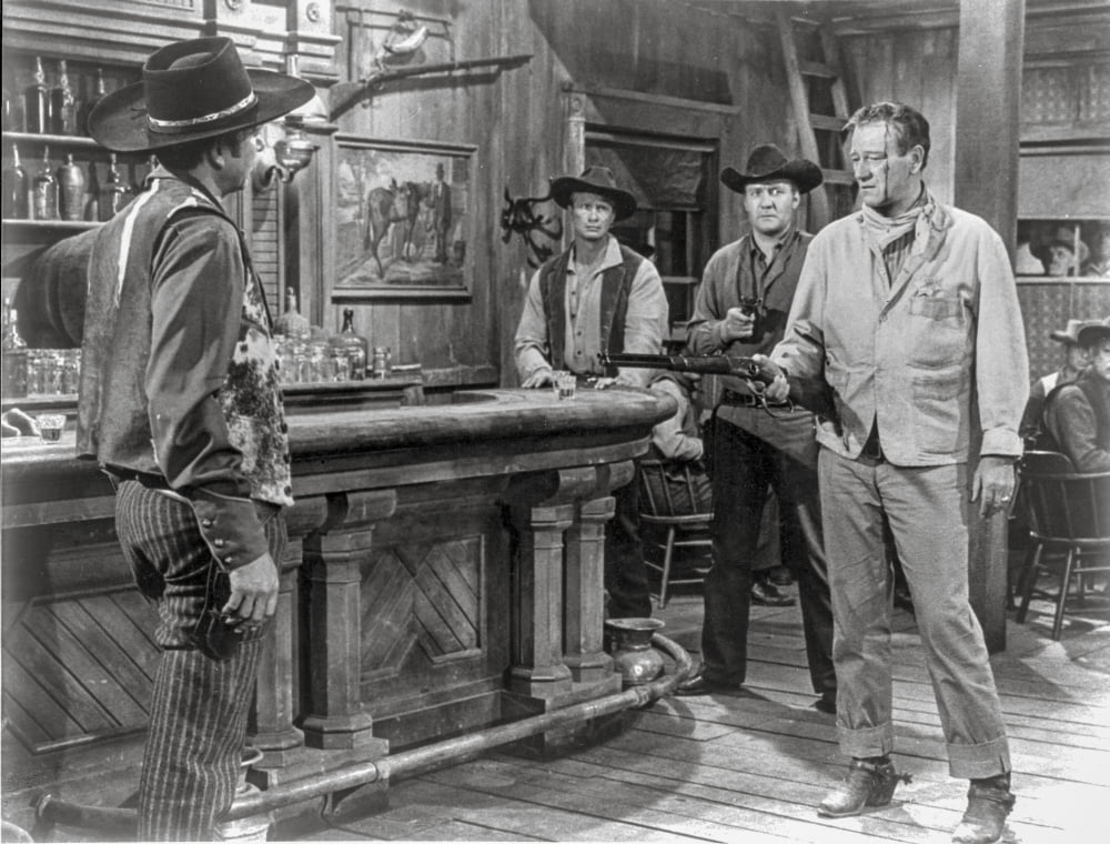 Rio Bravo cowboy photo print featuring a man pointing a gun in classic outfit.