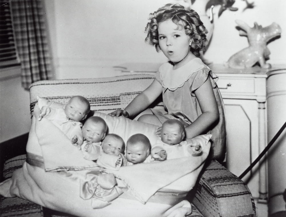 Shirley Temple playing with baby dolls photo print.