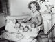 Shirley Temple playing with baby dolls photo print.