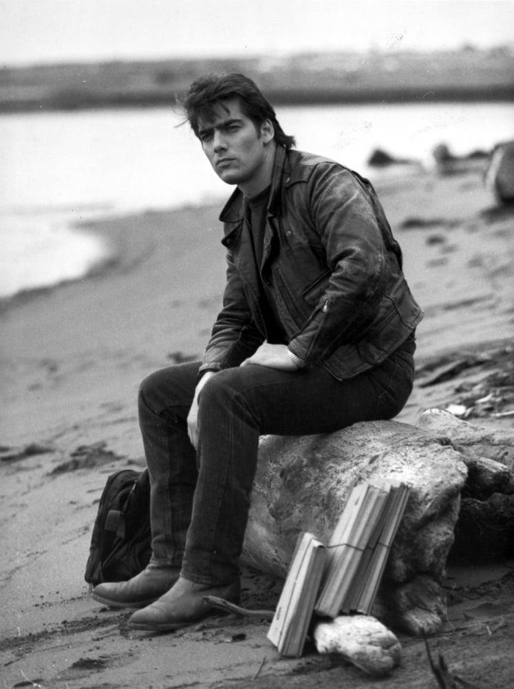 Ken Wahl relaxing on a rock at the beach photo print