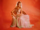 Elizabeth Montgomery in a pink sheer dress with an orange background photo print.
