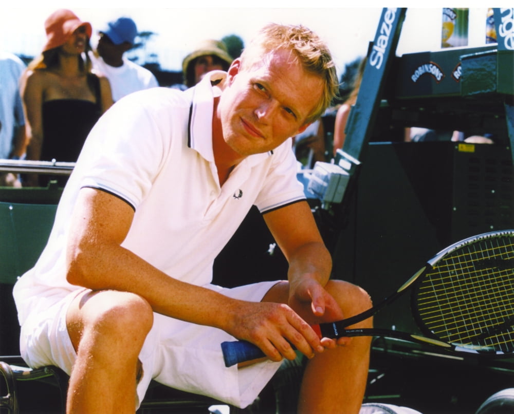 Photo print of Paul Bettany seated in a white polo shirt