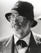 Sean Connery wearing a coat and glasses photo print.