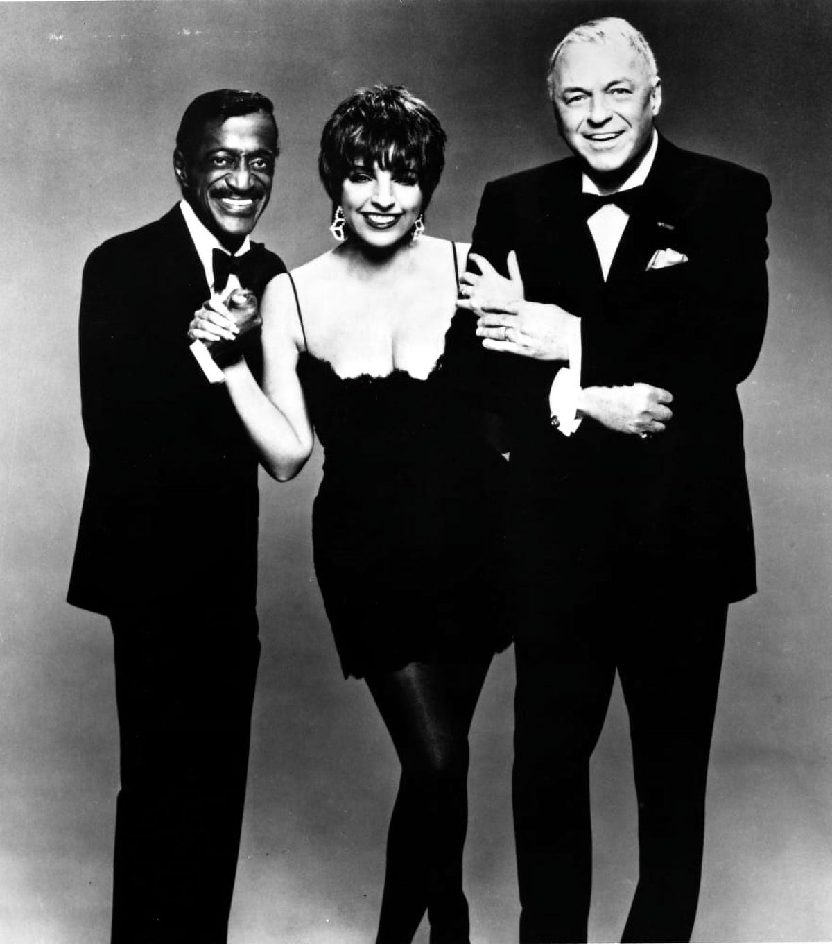Publicity still photo print featuring Sammy Davis Jr., Liza Minnelli, and Frank Sinatra, capturing a classic Hollywood moment.