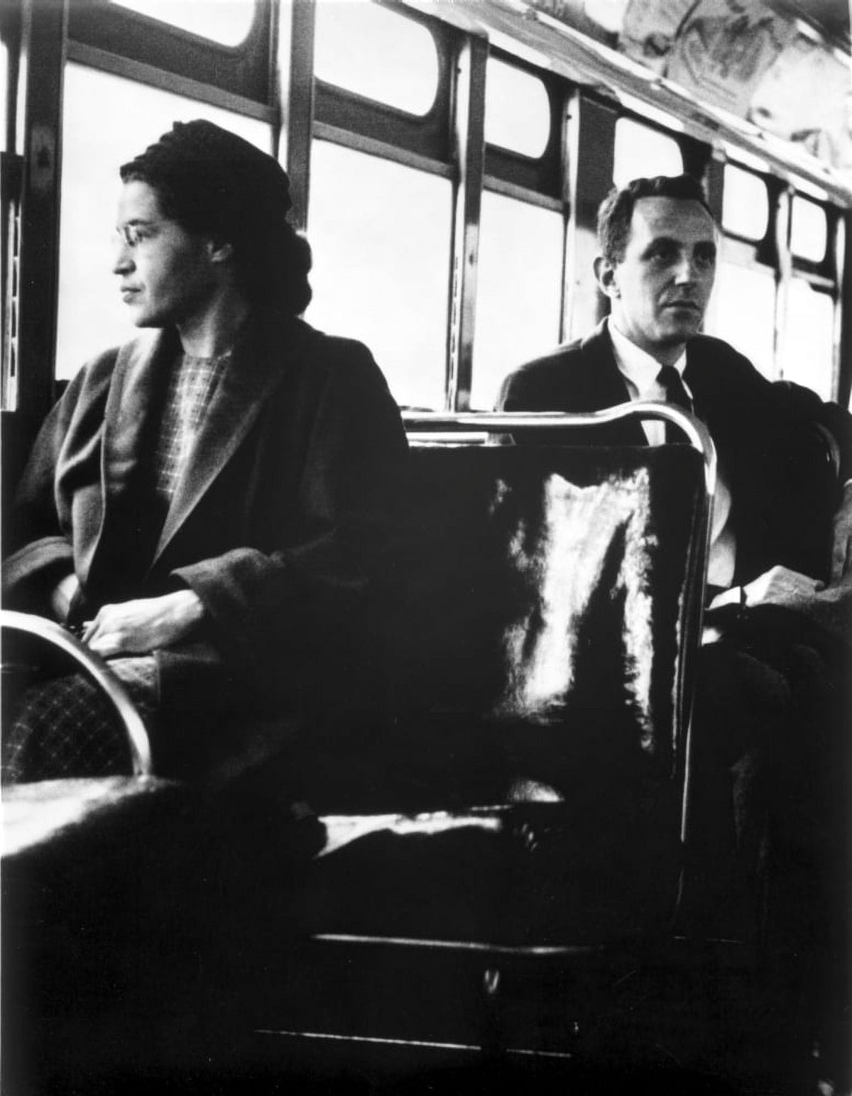 Rosa Parks seated on a public vehicle, iconic civil rights moment photo print.