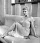 Kim Novak sitting on a bench in a flowing white gown photo print