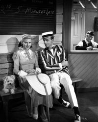 Fred Astaire and Ginger Rogers seated on a bench with a dog photo print.