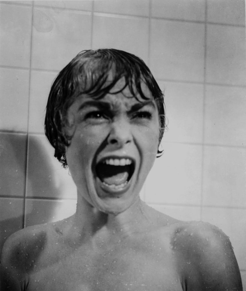 Black and white close-up portrait of a screaming woman from Psycho.