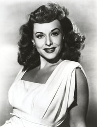 Paulette Goddard smiling portrait photo print in white dress.