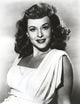 Paulette Goddard smiling portrait photo print in white dress.