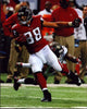 Tony Gonzalez running with football photo print, showcasing athletic prowess.