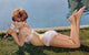 Deborah Walley laying on ground holding flower photo print