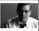 Black and white photo print of George Clooney in glasses and tie.