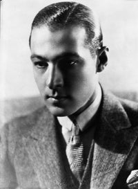 Black and white portrait photo print of Rudolph Valentino in a coat.
