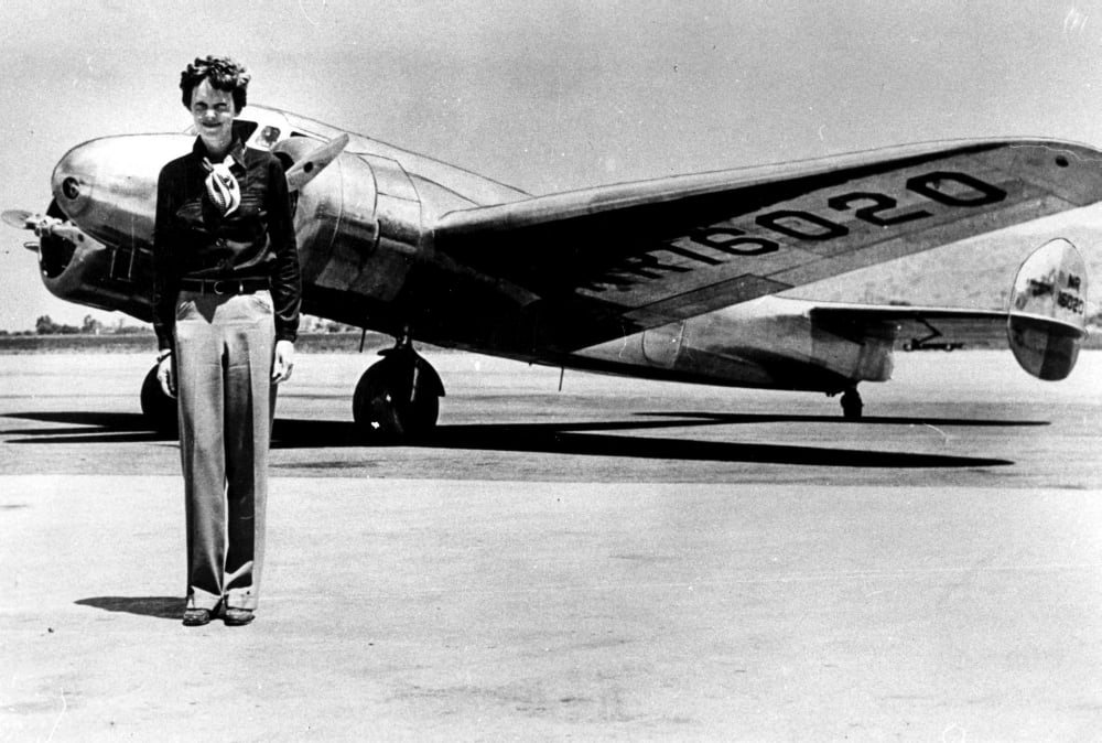 Amelia Earhart by an Airplane photo print showcasing aviation history.