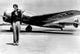 Amelia Earhart by an Airplane photo print showcasing aviation history.