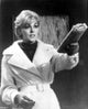 Kim Novak holding a newspaper photo print - classic Hollywood star